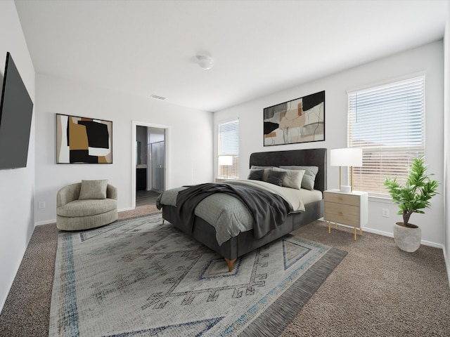 bedroom with connected bathroom, carpet floors, and multiple windows