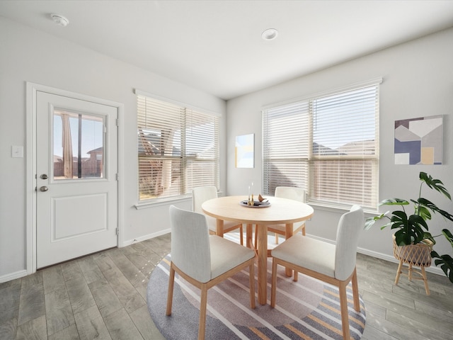 dining space with plenty of natural light and light hardwood / wood-style floors