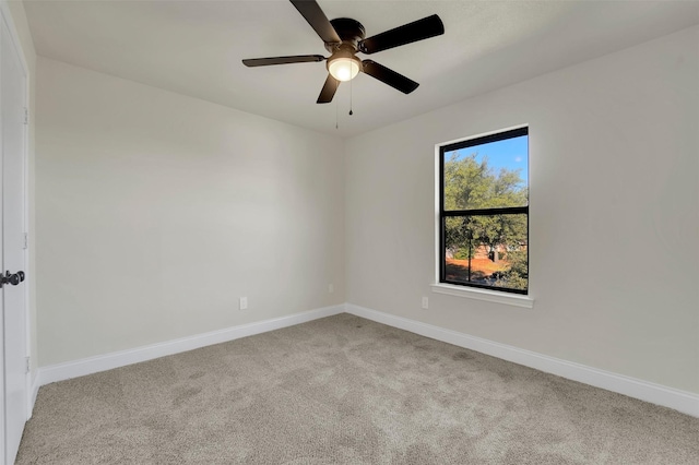 carpeted spare room with ceiling fan