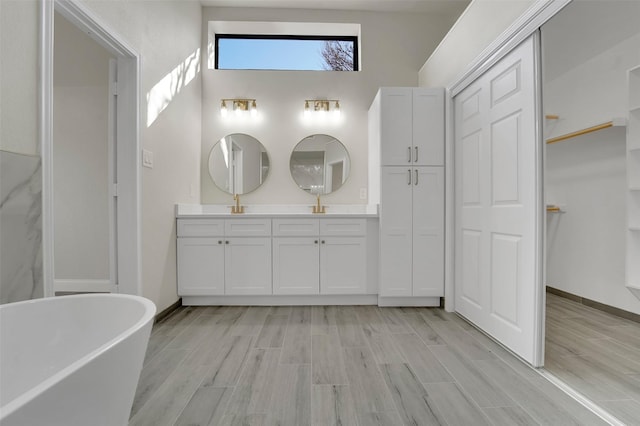 bathroom featuring a tub and vanity