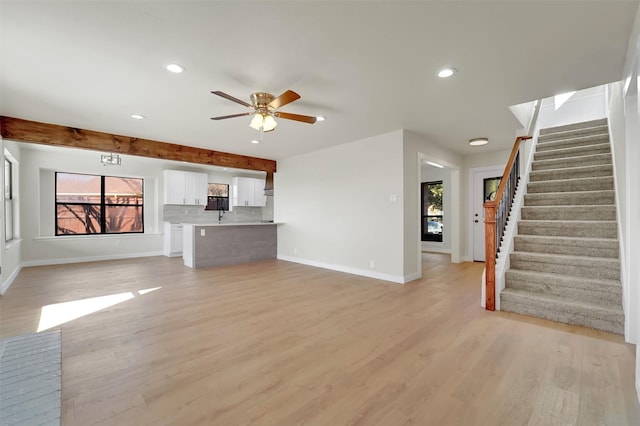 unfurnished living room with ceiling fan, plenty of natural light, and light hardwood / wood-style floors