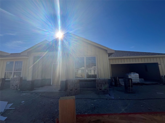 rear view of house with a garage