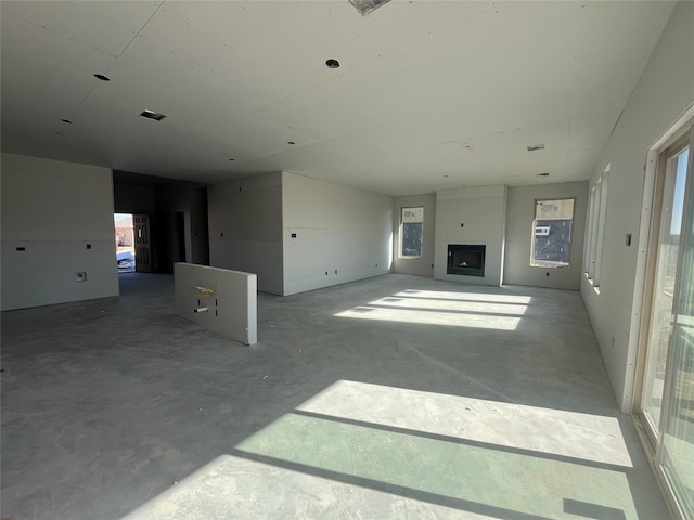 unfurnished living room featuring concrete floors