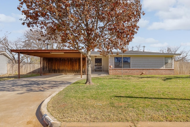 ranch-style home featuring a carport and a front lawn