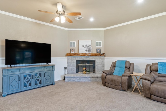 living room featuring light colored carpet, a brick fireplace, ceiling fan, and crown molding