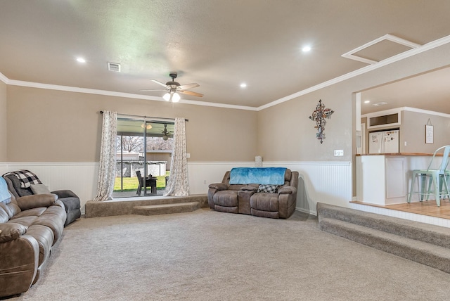 living room with carpet floors, ceiling fan, and crown molding