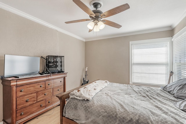 bedroom featuring ceiling fan, crown molding, and light hardwood / wood-style flooring