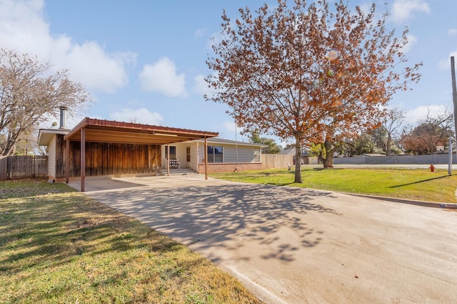 ranch-style house with a carport and a front lawn