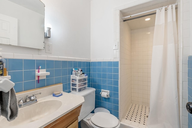 bathroom with a shower with curtain, vanity, toilet, and tile walls