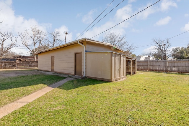 view of outbuilding featuring a yard