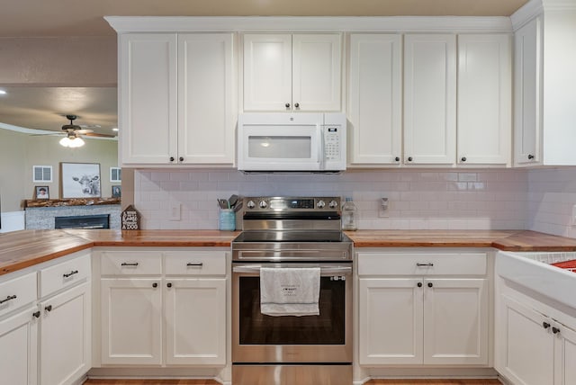 kitchen with wooden counters, backsplash, ceiling fan, electric stove, and white cabinets