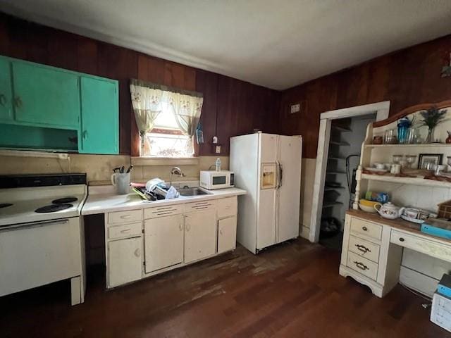 kitchen featuring dark hardwood / wood-style floors, wood walls, ventilation hood, sink, and white appliances