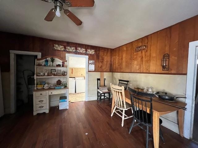 office space with ceiling fan, dark hardwood / wood-style flooring, built in desk, and washing machine and dryer