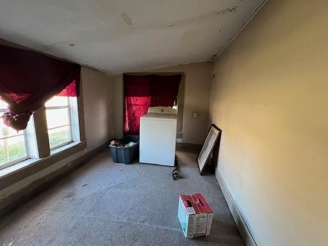 clothes washing area featuring washer / dryer and carpet