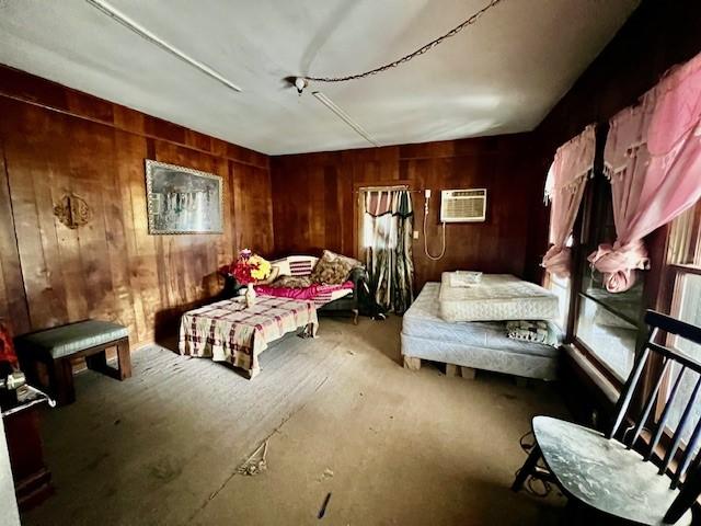 living area featuring a wall mounted AC and wood walls