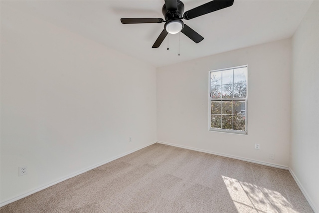 unfurnished room with ceiling fan and light colored carpet