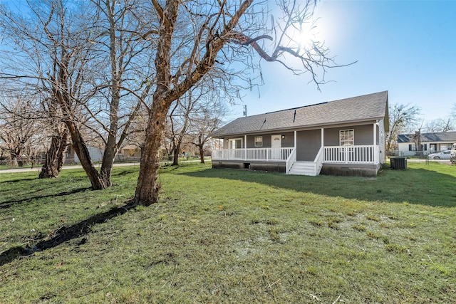 back of house featuring a yard, covered porch, and central air condition unit