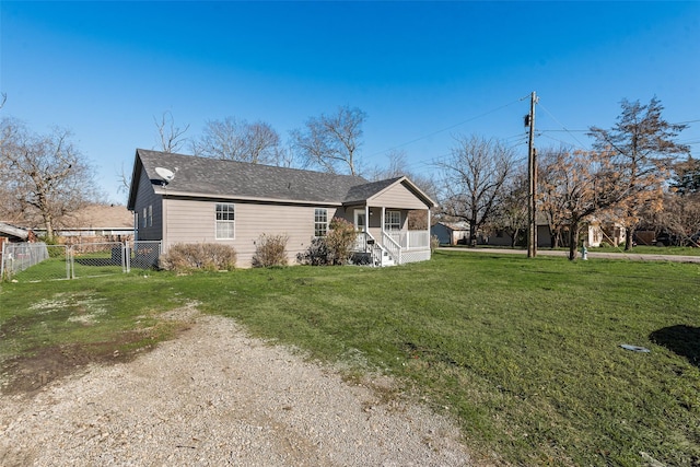 view of side of property with a porch and a lawn