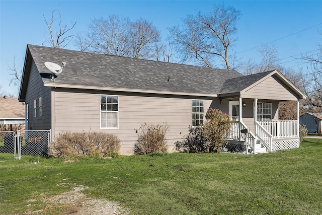 rear view of house featuring a porch and a yard