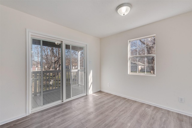 unfurnished room with light wood-type flooring