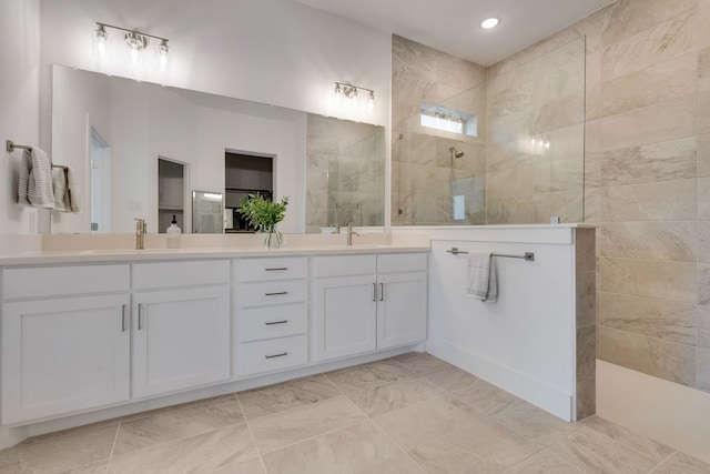 bathroom featuring vanity and a tile shower