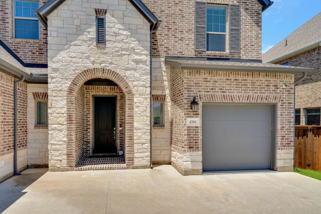 view of exterior entry with a garage