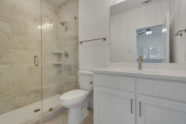 bathroom with ceiling fan, toilet, an enclosed shower, and vanity