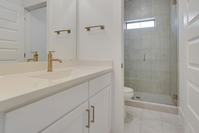 bathroom with tile patterned flooring, vanity, toilet, and an enclosed shower