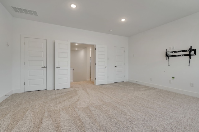 unfurnished bedroom featuring light colored carpet