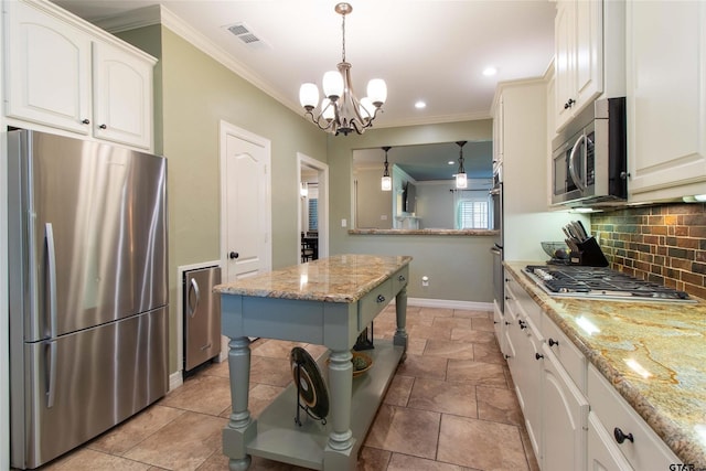 kitchen featuring light stone counters, a center island, hanging light fixtures, and appliances with stainless steel finishes