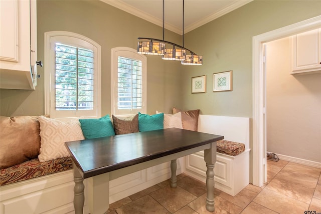 dining room featuring light tile patterned floors, breakfast area, and ornamental molding