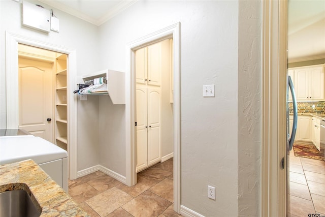 bathroom featuring washer / dryer, decorative backsplash, and ornamental molding