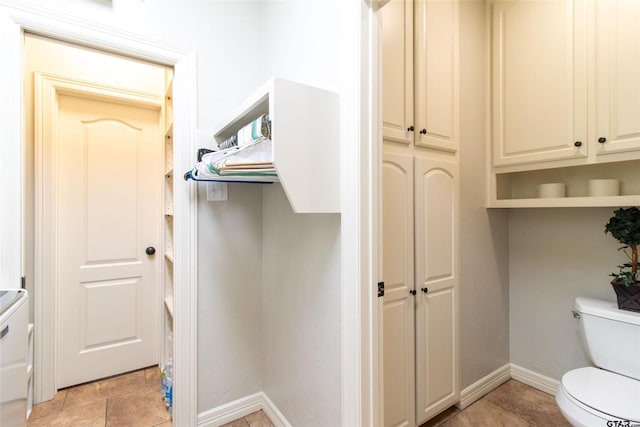 bathroom with tile patterned floors and toilet