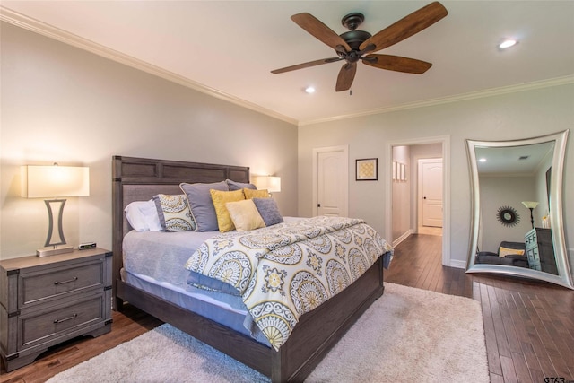 bedroom featuring dark hardwood / wood-style floors, ceiling fan, and ornamental molding