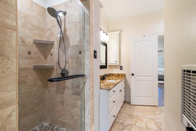 bathroom featuring vanity, an enclosed shower, and crown molding