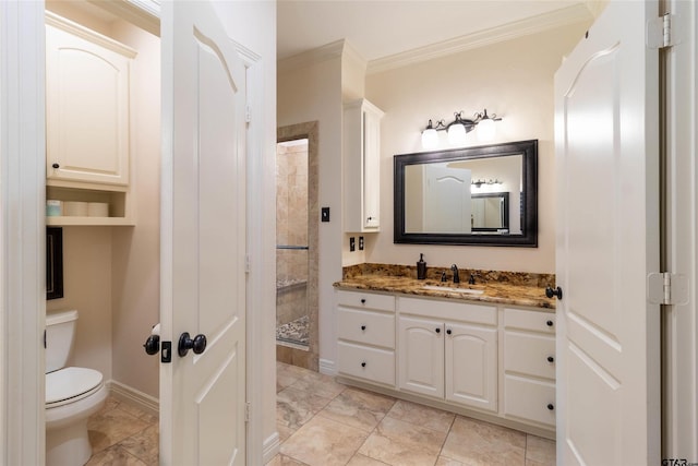 bathroom featuring tiled shower, toilet, vanity, and ornamental molding