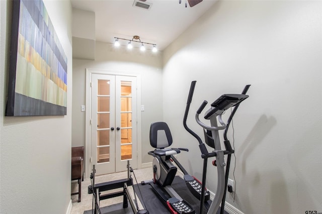 workout area with ceiling fan and rail lighting