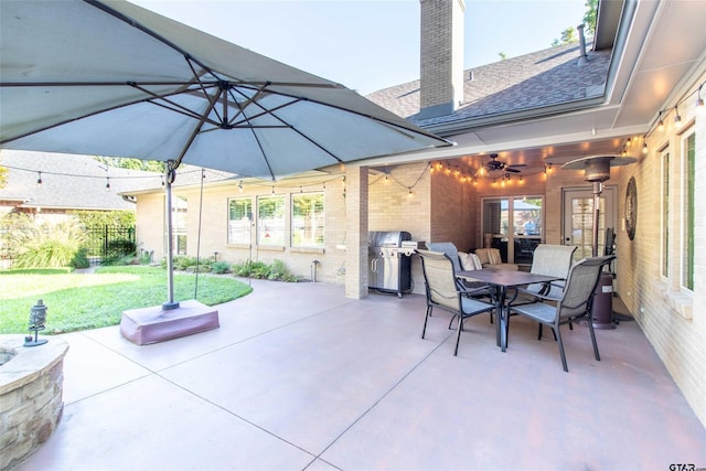 view of patio featuring area for grilling and ceiling fan