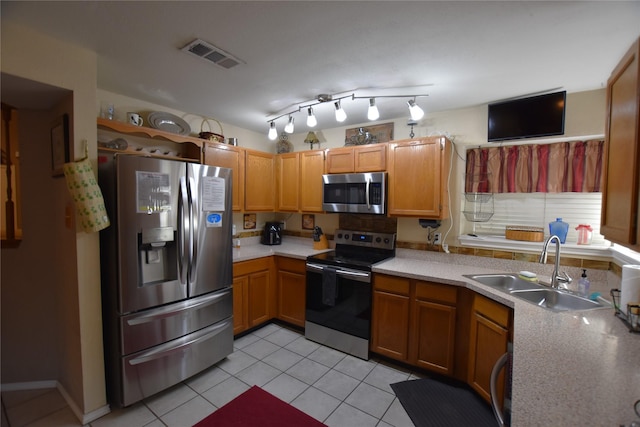 kitchen with light tile patterned floors, sink, and appliances with stainless steel finishes