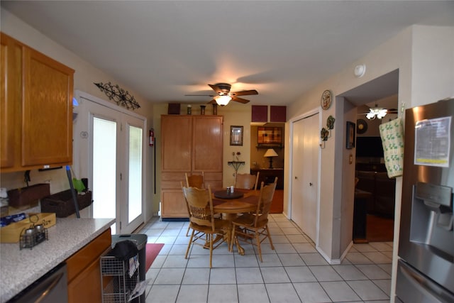 dining space featuring ceiling fan and light tile patterned floors