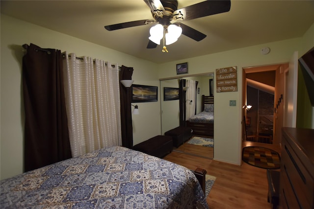 bedroom with ceiling fan, a closet, and wood-type flooring