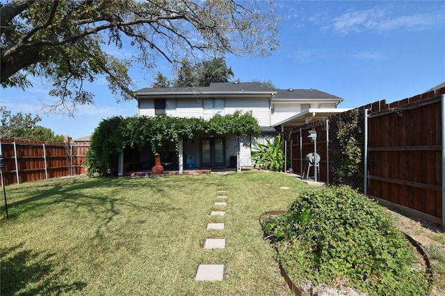 back of property featuring a lawn and french doors