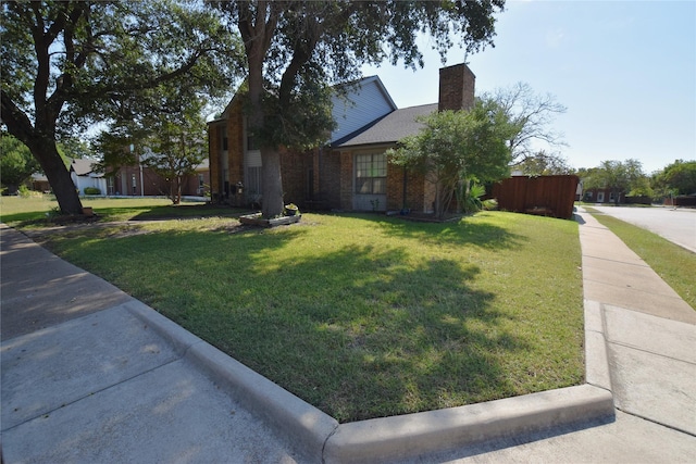 view of side of property featuring a yard