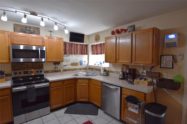 kitchen with sink, light tile patterned flooring, and appliances with stainless steel finishes