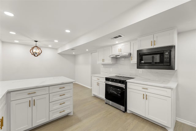 kitchen featuring pendant lighting, black microwave, light wood-type flooring, electric stove, and white cabinets