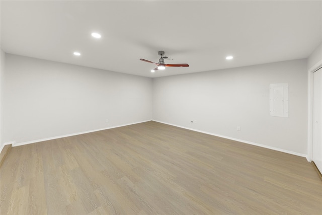 empty room with ceiling fan and light hardwood / wood-style floors