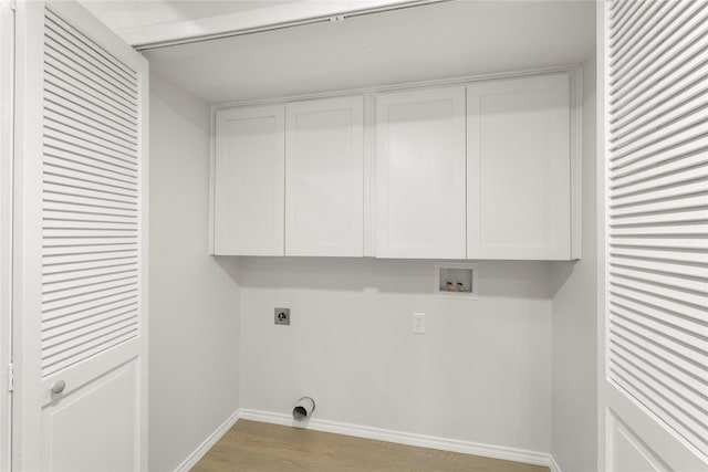 laundry area featuring hookup for an electric dryer, light hardwood / wood-style floors, cabinets, and hookup for a washing machine