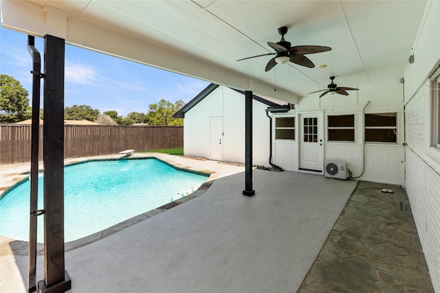 view of pool featuring ac unit, a diving board, a patio area, and ceiling fan