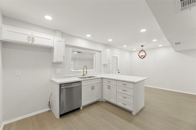 kitchen featuring dishwasher, sink, white cabinets, and light hardwood / wood-style floors