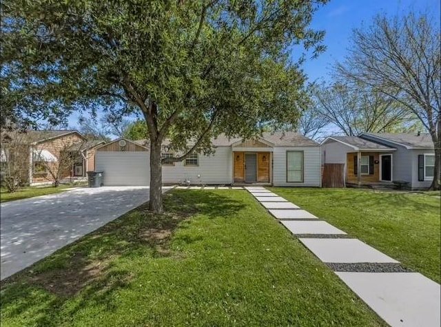 single story home featuring an outbuilding, a garage, and a front yard